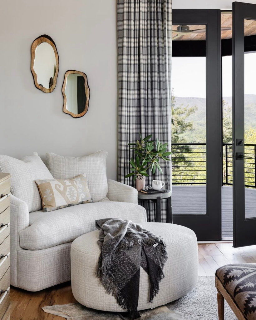 Revolution fabrics on a chair and ottoman and drapery in a master sitting area.