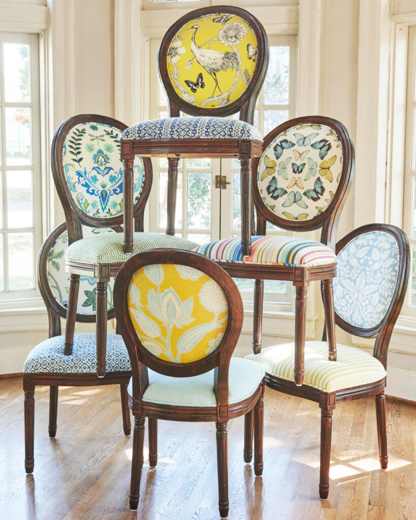Revolution fabrics on dining chairs in multiple colors stacked on top of each other.