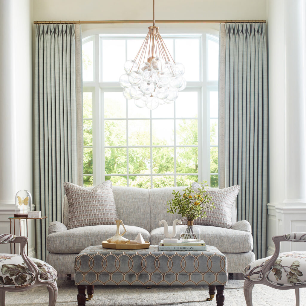 Family room with revolution fabrics on furniture and drapery in soft colors.