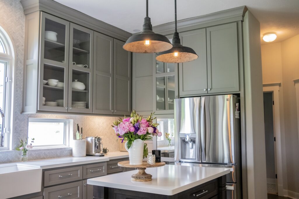 Kitchen with transitional style design with quartz countertops and a gray finish cabinets. Kitchen renovation Houston.