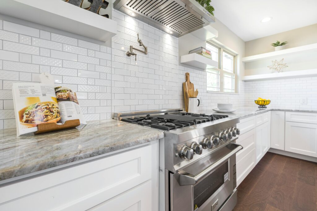 Minimal kitchen remodel with tile backsplash and marble countertops. Kitchen renovation Houston. 