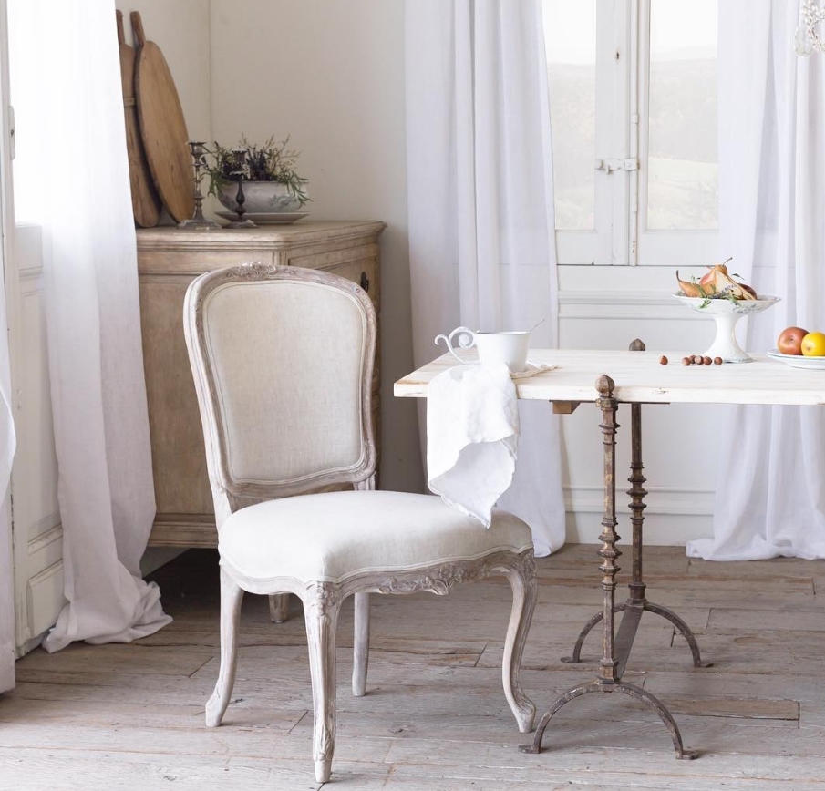 French Home Interiors in a breakfast area with mixed materials like marble and iron table.
