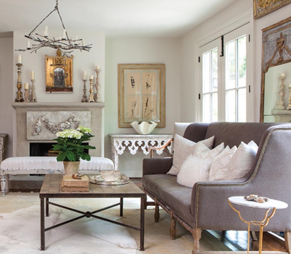 French Home Interiors style with ornate carvings on furniture and fireplace.