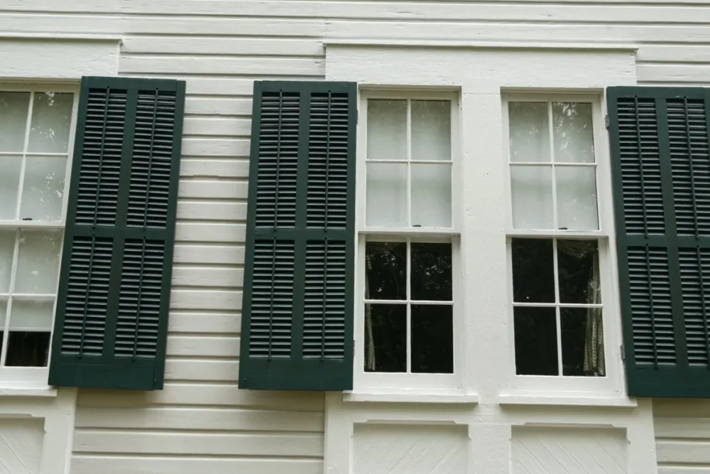 Colonial Shutters that function and protect exterior windows from elements. 